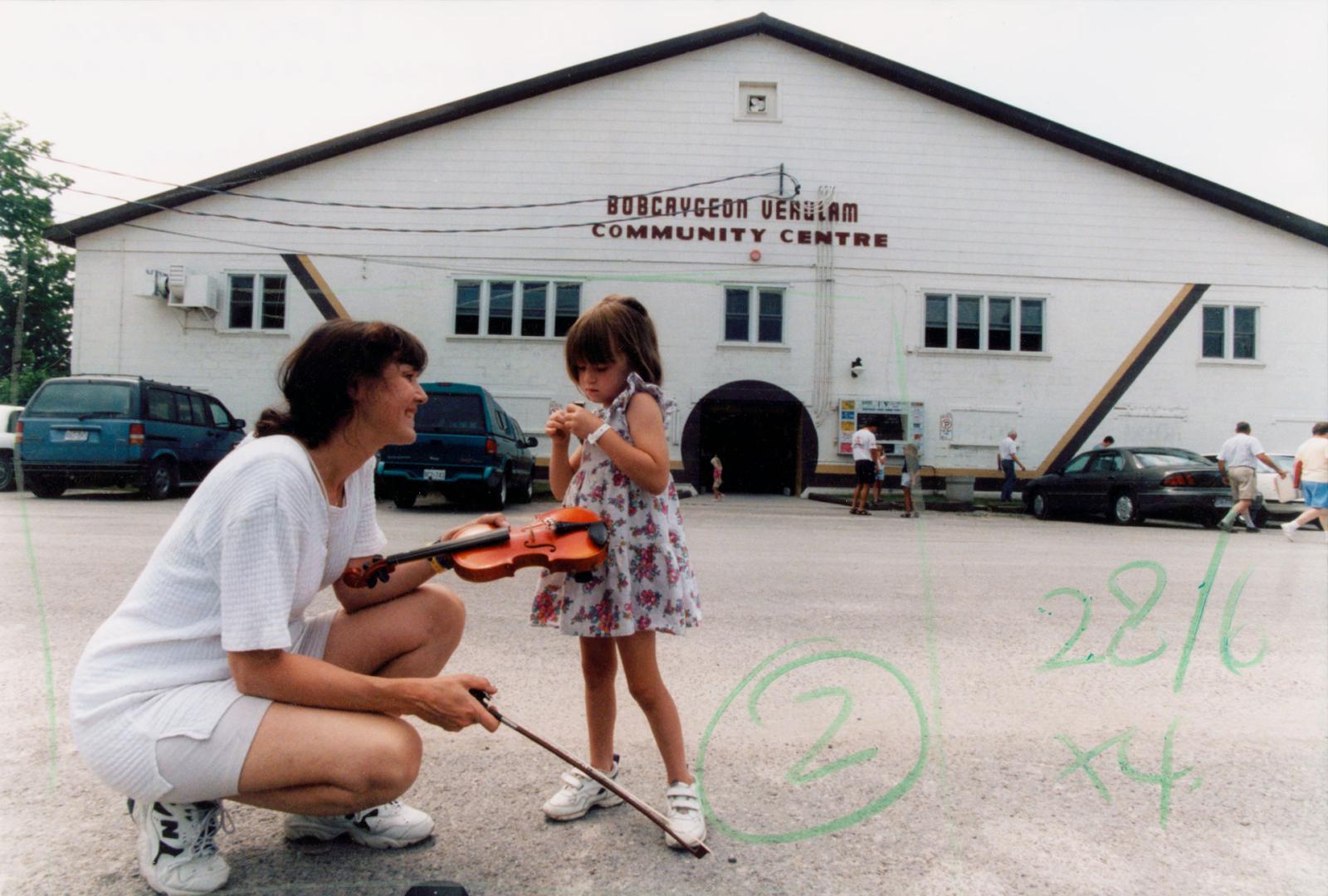 Savannah Dares, 4, and mother Karen in front of the Bobcaygeon Verulam Community Centre, Kawartha Lakes Ontario Open Fiddle and Step Dance Contest. Bobcaygeon, Ontario