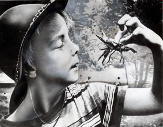 Joey takes a closer look at a crayfish he found while at Bolton Camp.  Bolton, Ontario