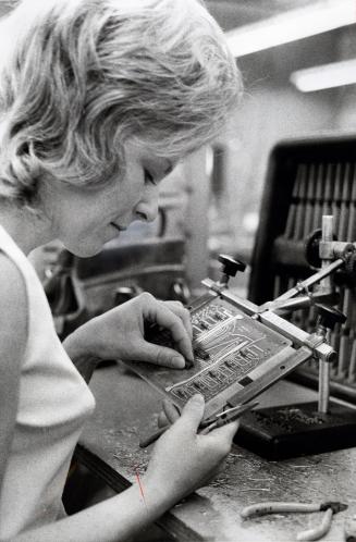 Pat Little sets up a printed conduit board assembly in the Honeywell plant.  Bowmanville, Ontario