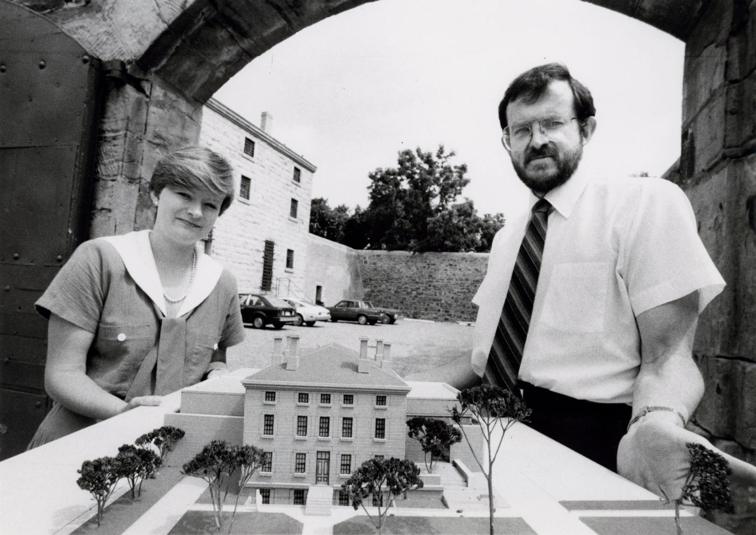 Bill Barber, curator of Region of Peel Museum, and archivist Ann ten Cate standing beside a model of Brampton Jail. Brampton, Ontario