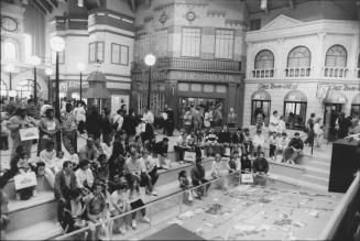 Visitors in the amphitheatre watch as buildings light up on scale model of the community. Brampton, Ontario