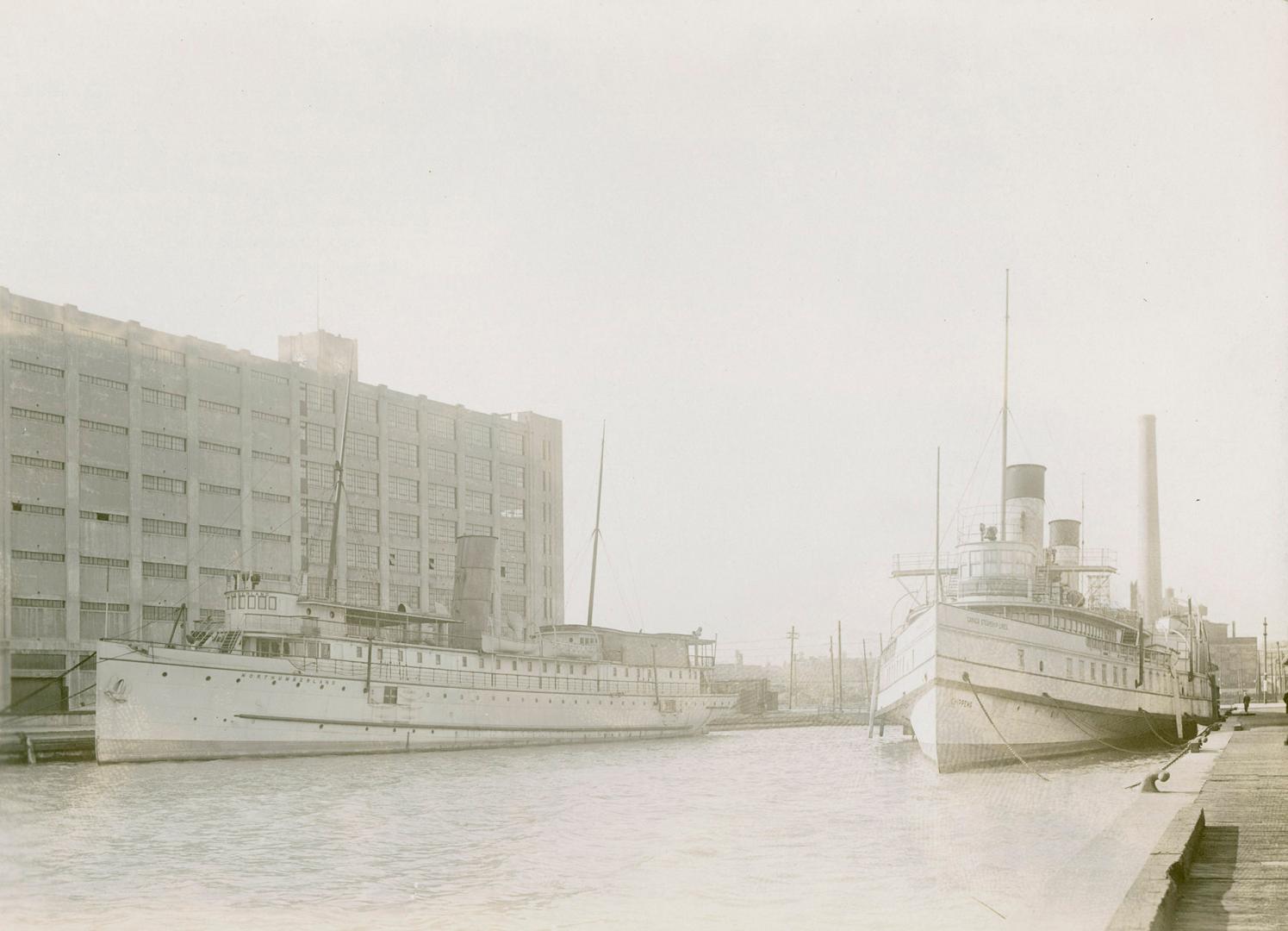 Image shows a few boats by the terminal warehouses.