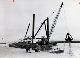 A dredge at work in Bronte Harbour. Bronte, Ontario