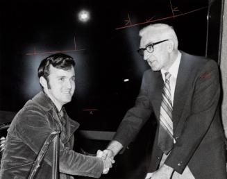 Motorist Jim Mutch (left) is congratulated by bridge superintendent Jim Stelling as first to cross the now toll-free Burlington Skyway. Burlington, Ontario