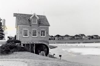 Replica Old Mill at the entrance to Millcroft development serves as pumping station for golf clubs. Burlington, Ontario