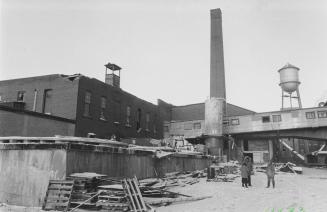 Dominion Woollens and Worsteds.  The historic silk knit mill being demolished, beside the Speed River in Hespeler. Cambridge, Ontario