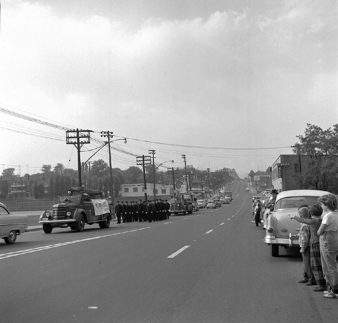 Image shows a parade along the street.