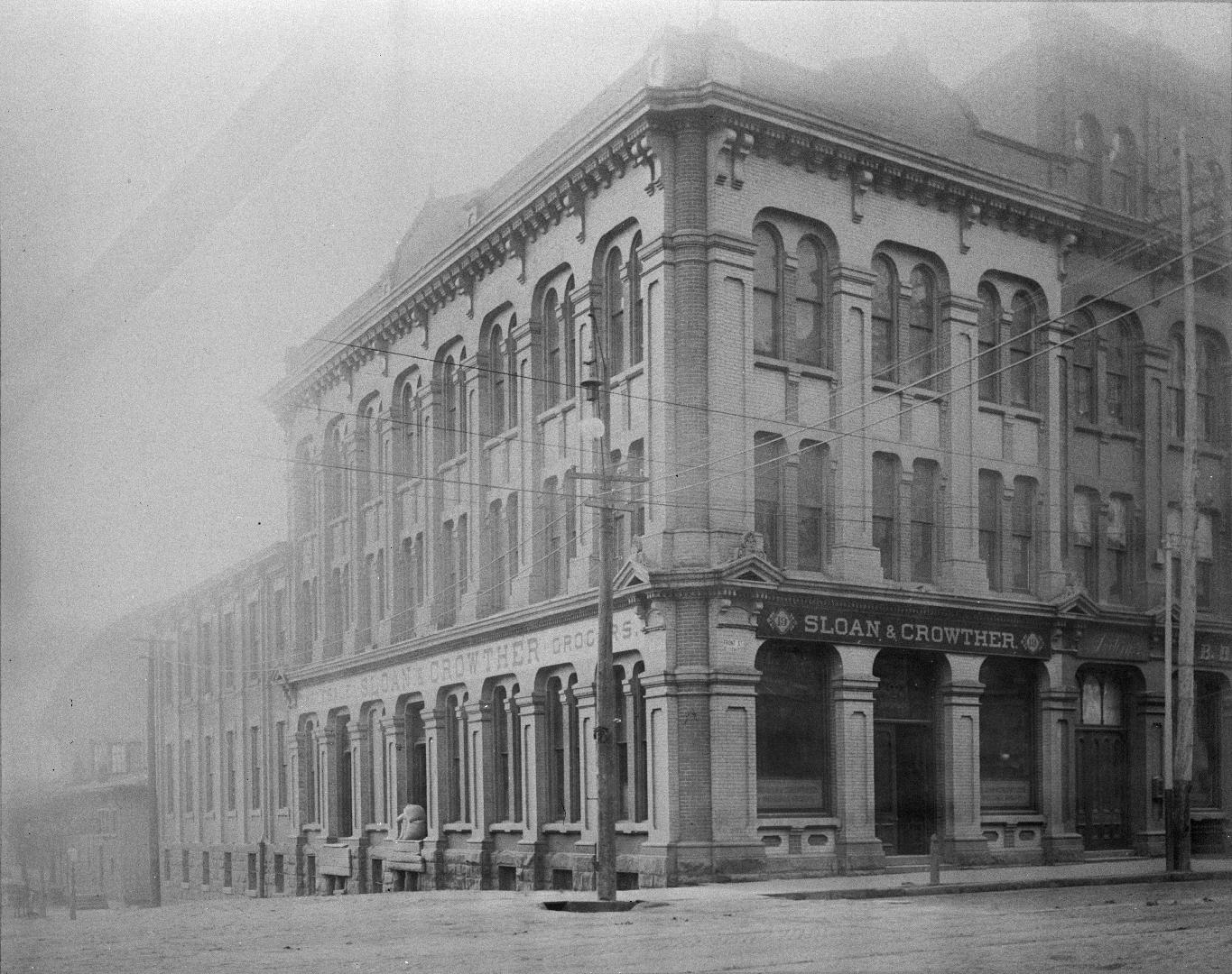 Scott St., southwest corner Front Street East, showing Sloan & Crowther, wholesale grocers, on corner and Great Western Station in background