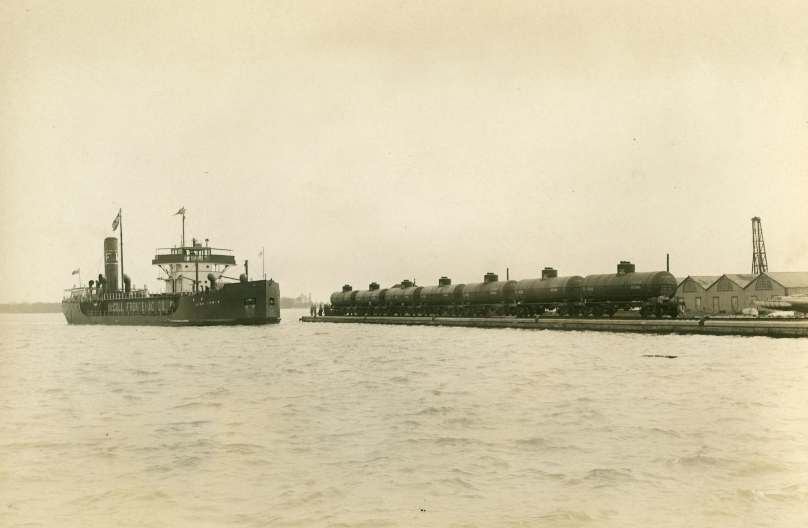 Image shows a lake view with a ship and a wharf in the background.