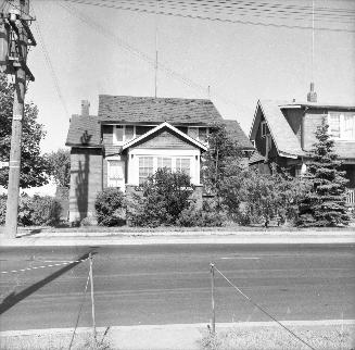 Image shows a few two storey buildings across the street.