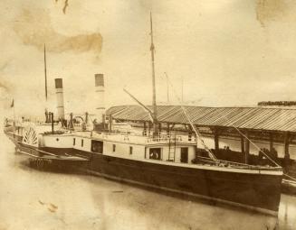 Image shows a paddle steamer by the wharf.