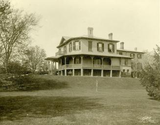 Image shows a three storey house on the hill.