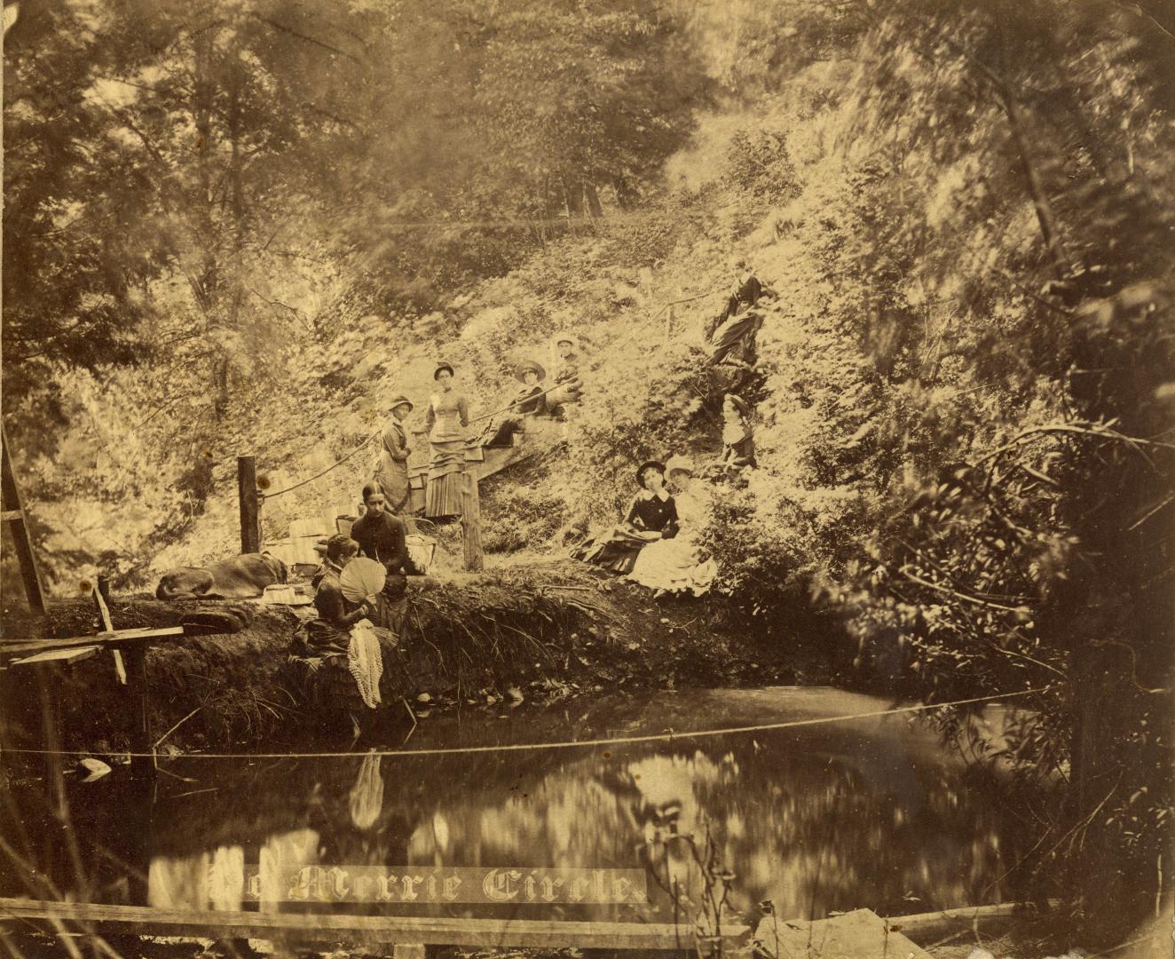 Image shows some people standing by the reservoir.