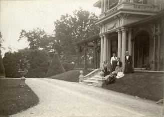 Image shows a group of people posing for a photo on the staircase of the building.