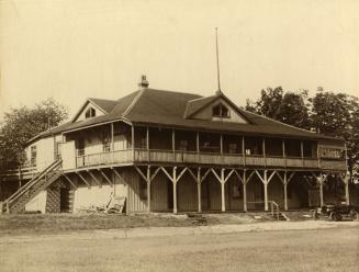 Image shows a two storey building in the park.