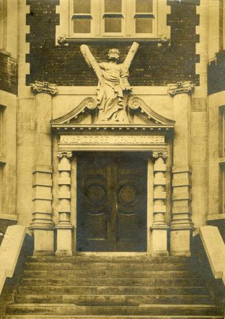 Image shows the staircase leading towards the entrance doors.