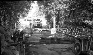 Image shows a bridge over stream.