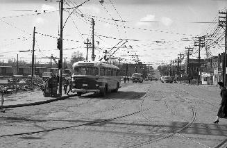 Image shows a street view at Eglinton and Yonge intersection in Toronto, Ontario. There is a tr…