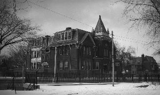 Image shows a three storey building along the street.