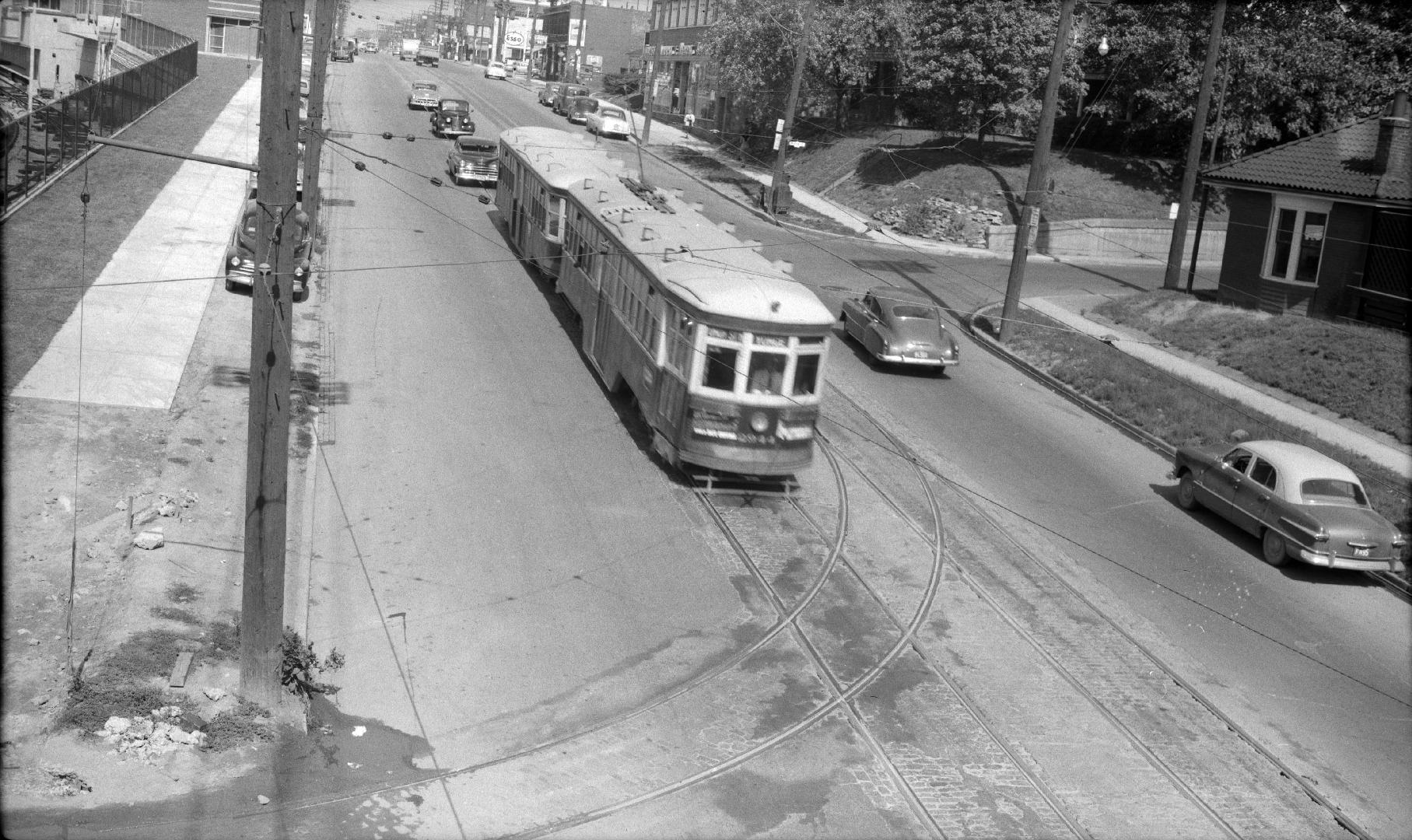 Yonge St. looking north from G.T.R. Belt Line bridge south of Merton St. Image shows a streetca…