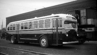  Image shows a bus by the building.
