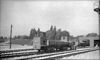 Subway Car #RT. 3, at Davisville yards. Image shows a dump car on the tracks and a few employee…