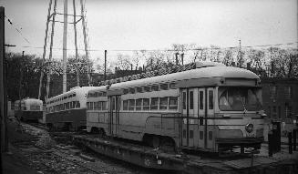 Image shows a few rail cars on tracks.