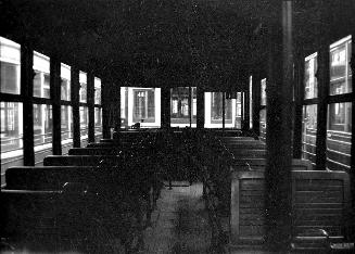  Image shows an interior of a rail car.
