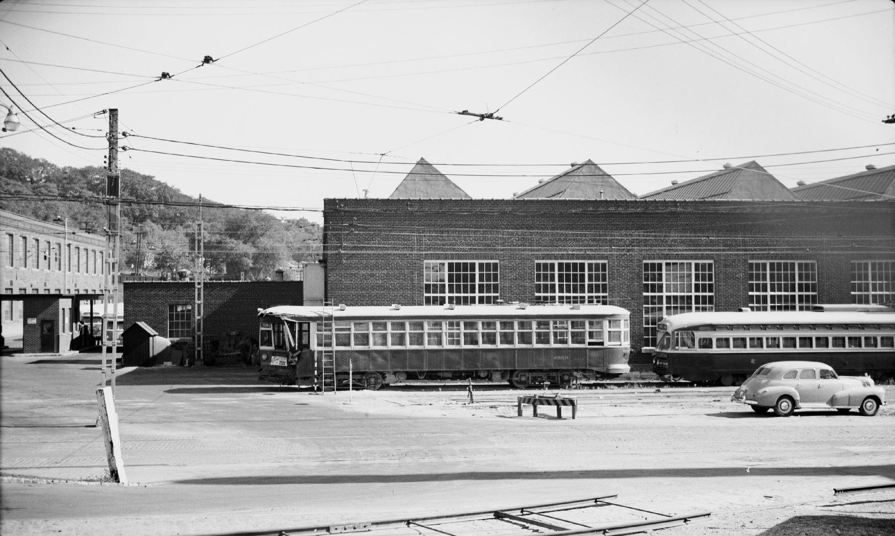 Image shows a few rail cars beside the building. 