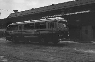  Image shows a bus by the building.
