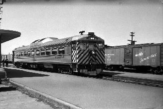 Image shows a few trains on tracks at the platform.