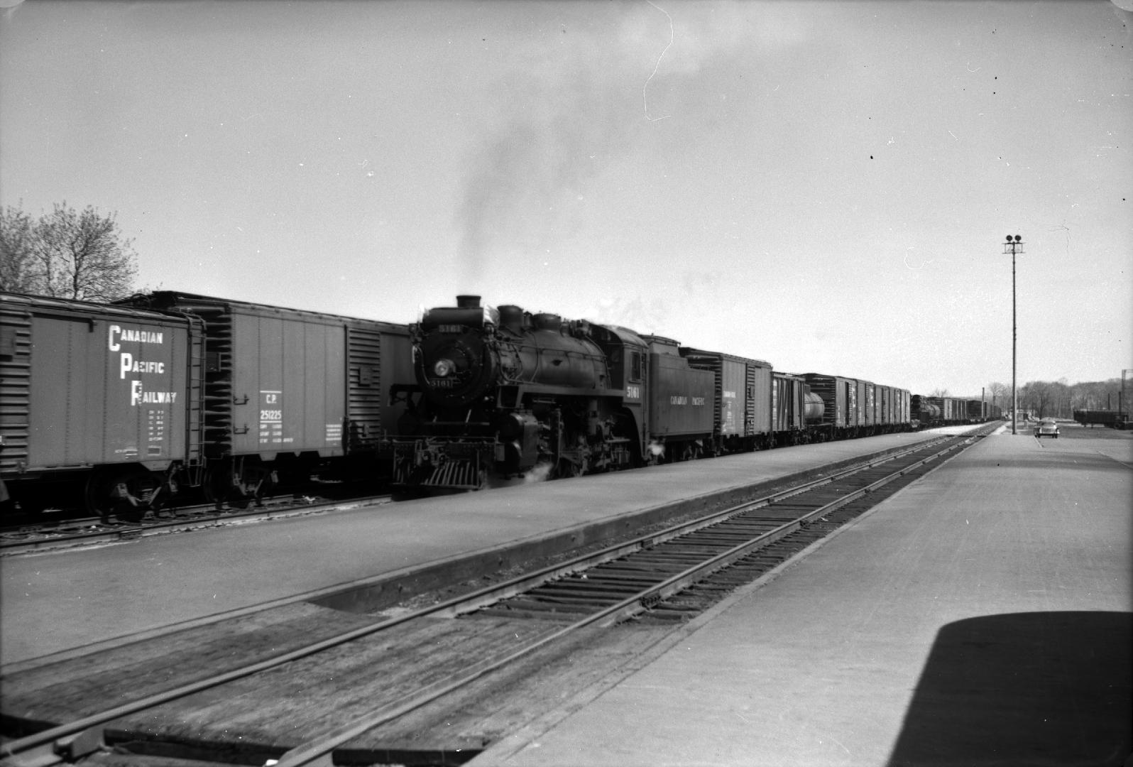 Image shows a track view and a few trains at the platform.