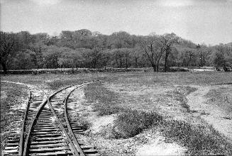 Image shows a track view with the river and trees in the background.