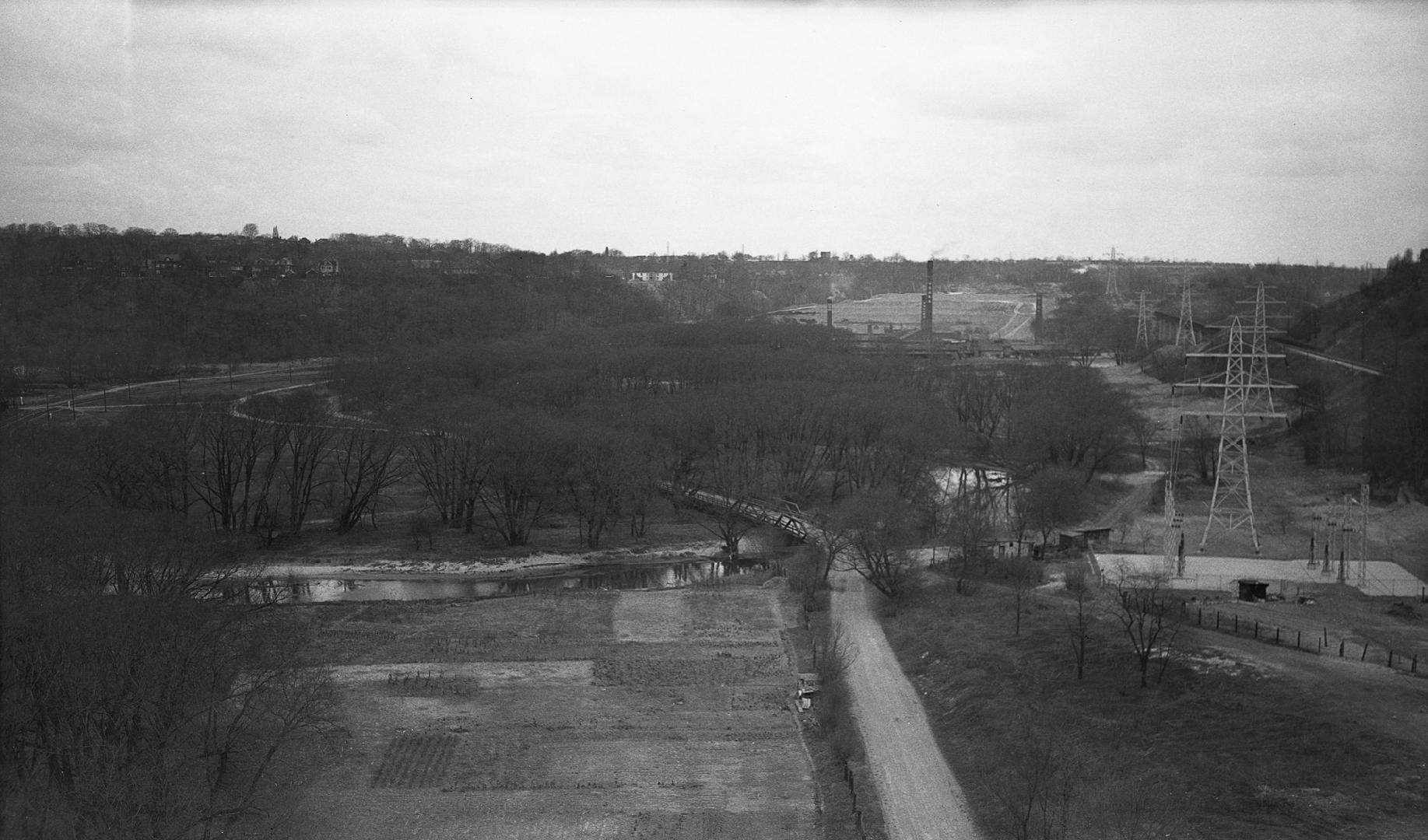 Image shows a street view from the viaduct and some trees around.