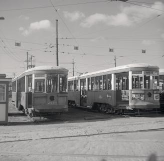 T.T.C., #2416 (on left), being scrapped, at Russell carhouse, also showing #2438 being scrapped on right