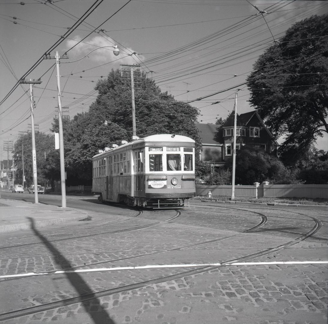 T.T.C., #2762, on Queen Street East, looking west from Connaught Avenue