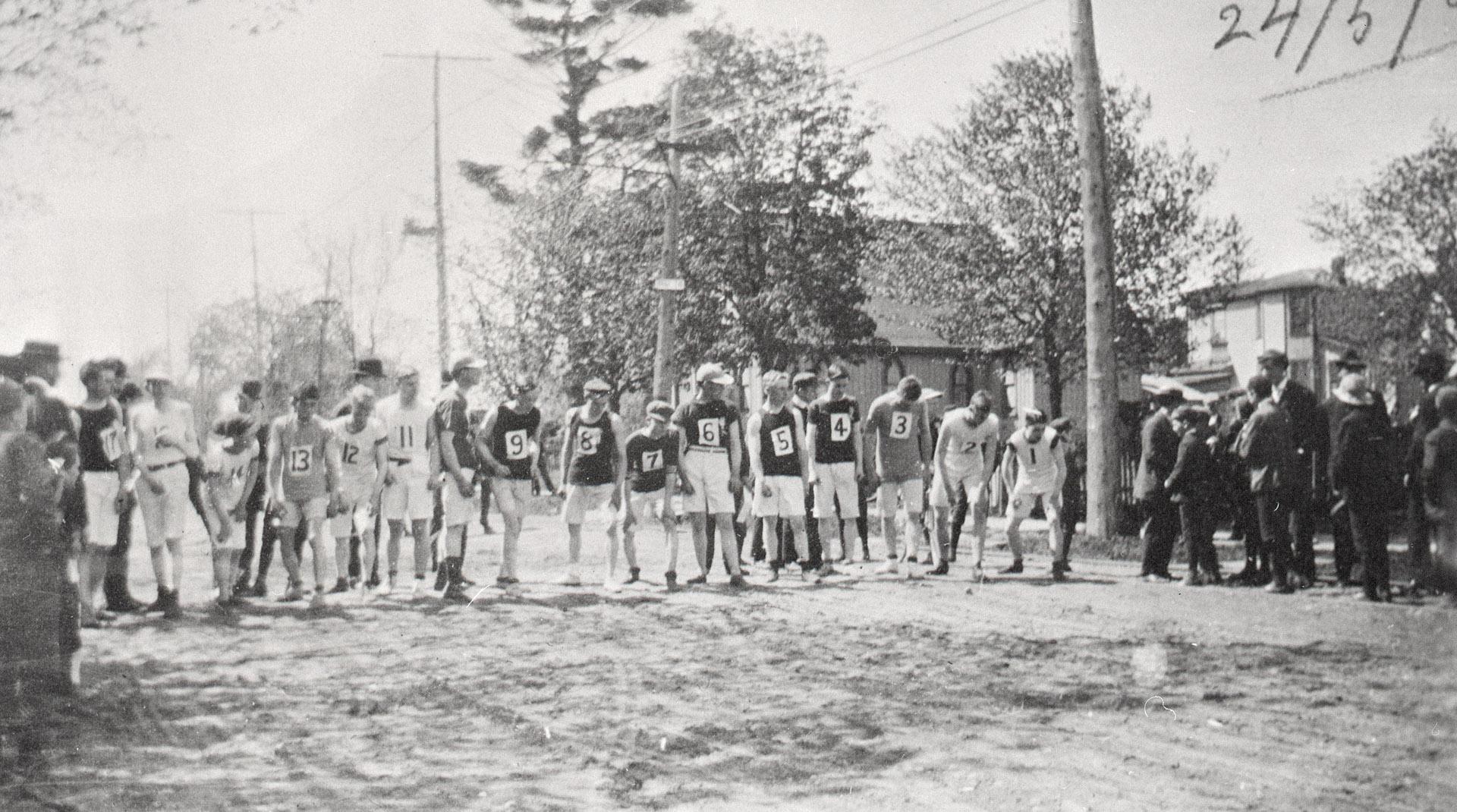 Race, North Toronto. Image shows a group of runners ready to start a race. There are some spect…