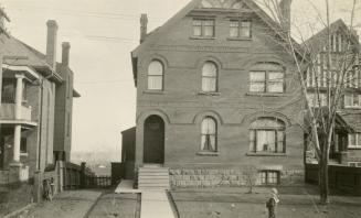 Image shows a three storey house.