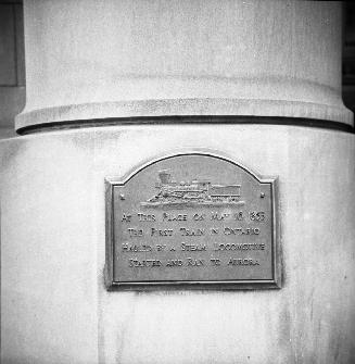 Railway, plaque commemorating first train in Ontario hauled by a steam locomotive, on Union Station (opened 1927)