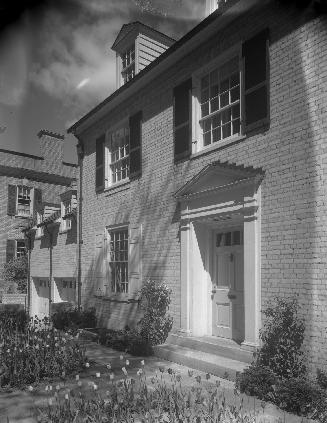 Image shows a limited view of the front side of a two storey house.