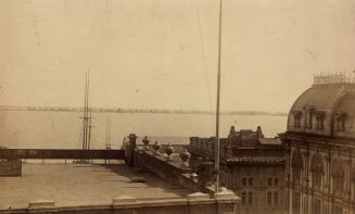 Image shows the rooftops of some waterfront building with the lake in the background.