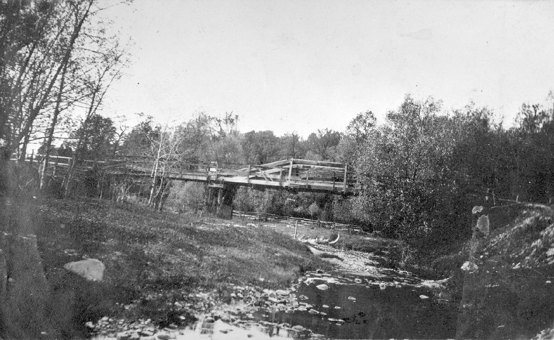 Image shows a wooden bridge over Don river, Toronto, Ontario. 