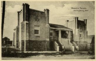 Two brick towers connected by an entrance with two sets of stairs