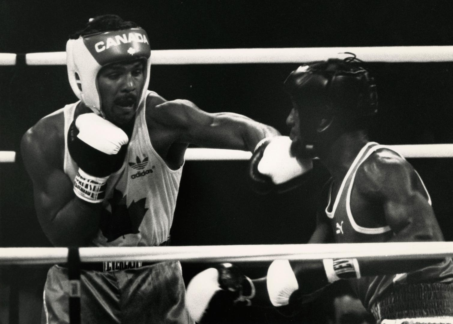 Nick Rupa of Canada lands a left to the chin of Pedro Frias