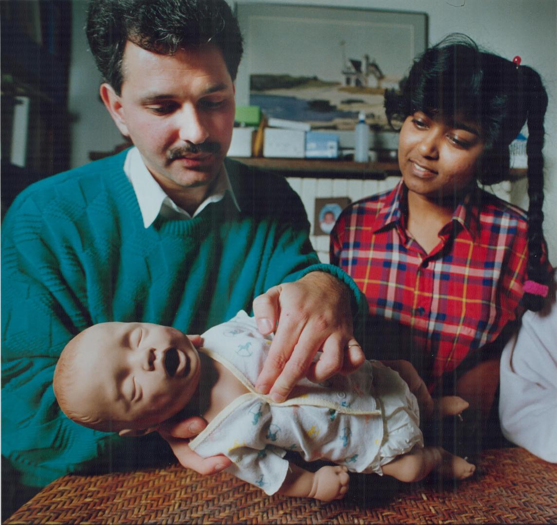 Instructor Stephen Brass demonstrates lifesaving technique to nanny Jenny Dass