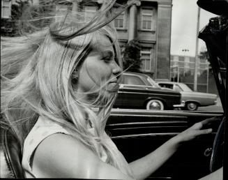 Michele Hollingworth demonstrates how long, blowing hair can block a driver's vision