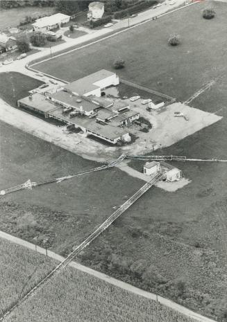 Wreckage of television transmission tower (on ground) and FM transmission tower (on roof) strews crash scene after a twin-engined airplane struck the (...)