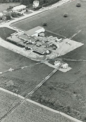 Wreckage of television transmission tower (on ground) and FM transmission tower (on roof) strews crash scene after a twin-engined airplane struck the (...)