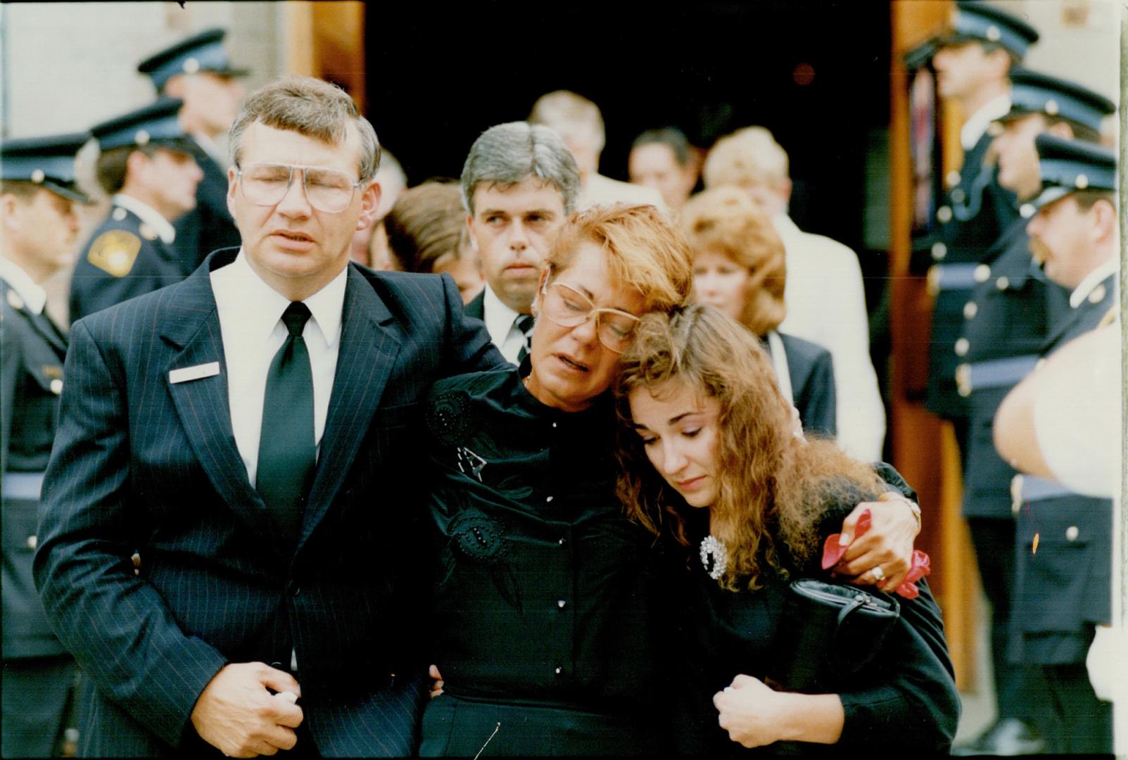 Grieving Family: Capt. Shane Antaya s wife, Susan, mother Marcia and stepfather Garry Daly console each other as they leave the church yesterday