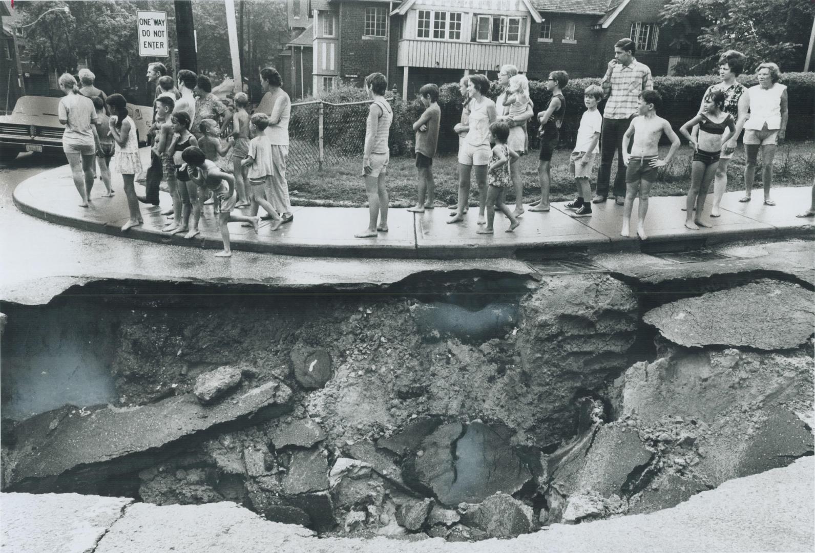 The street fell in at the corner of Logan and Bain Aves